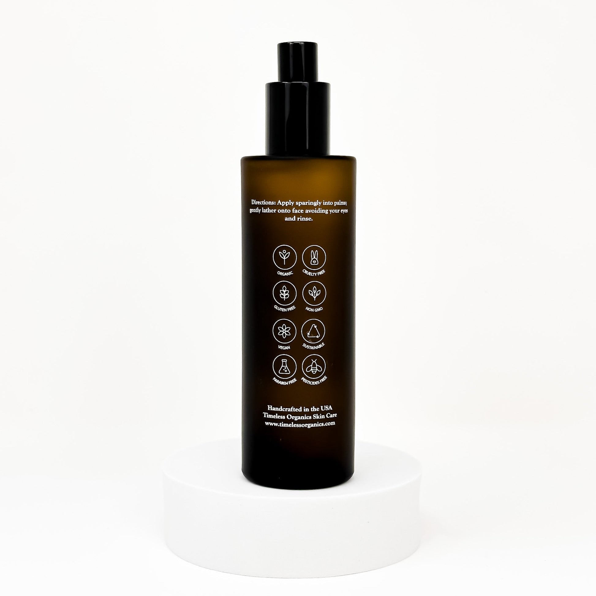 Clarifying facial toner bottle with black pump; back label with icons and directions