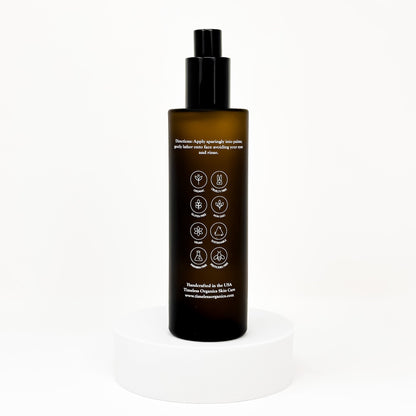 Clarifying facial toner bottle with black pump; back label with icons and directions