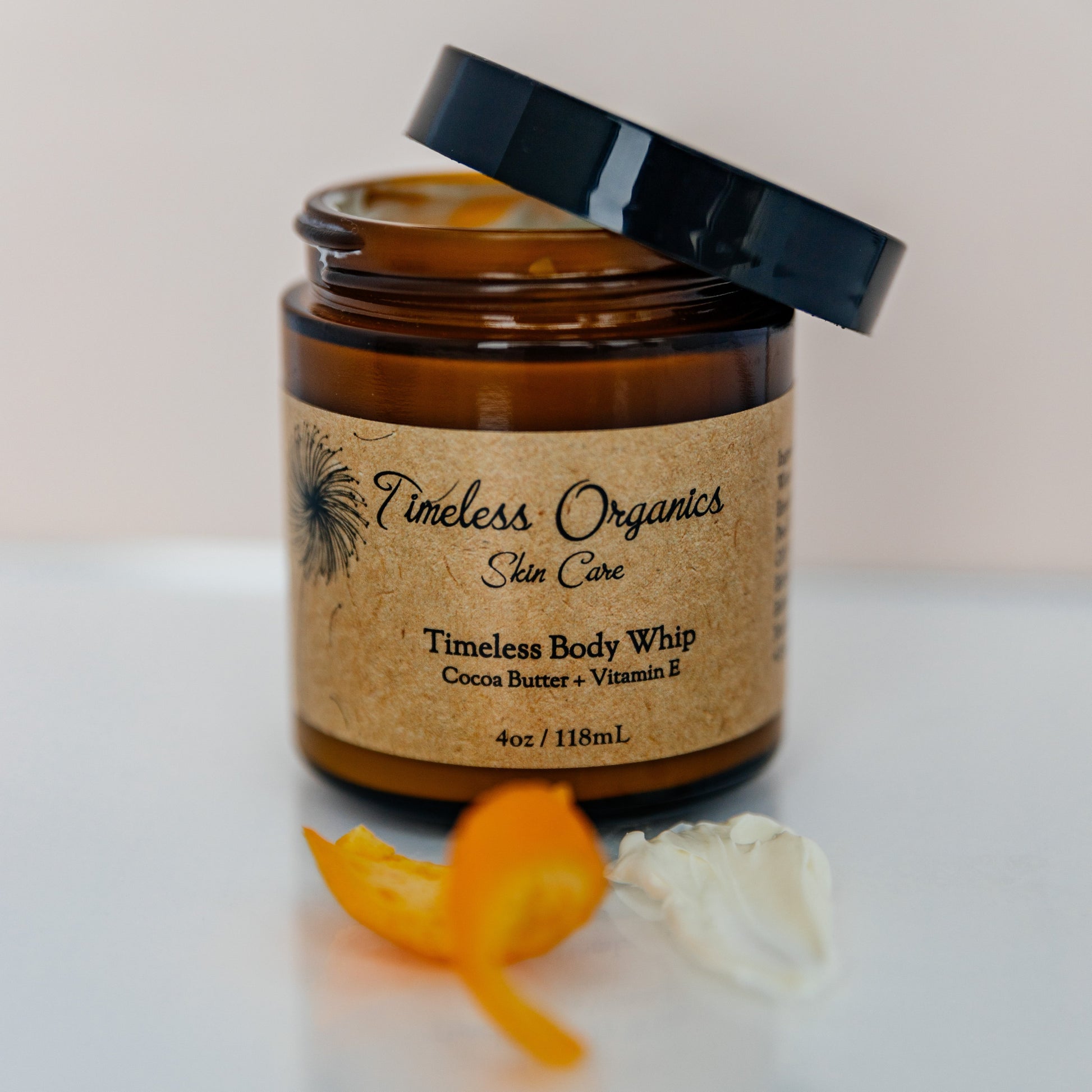 Cocoa butter body whip jar with black lid and cream swirls