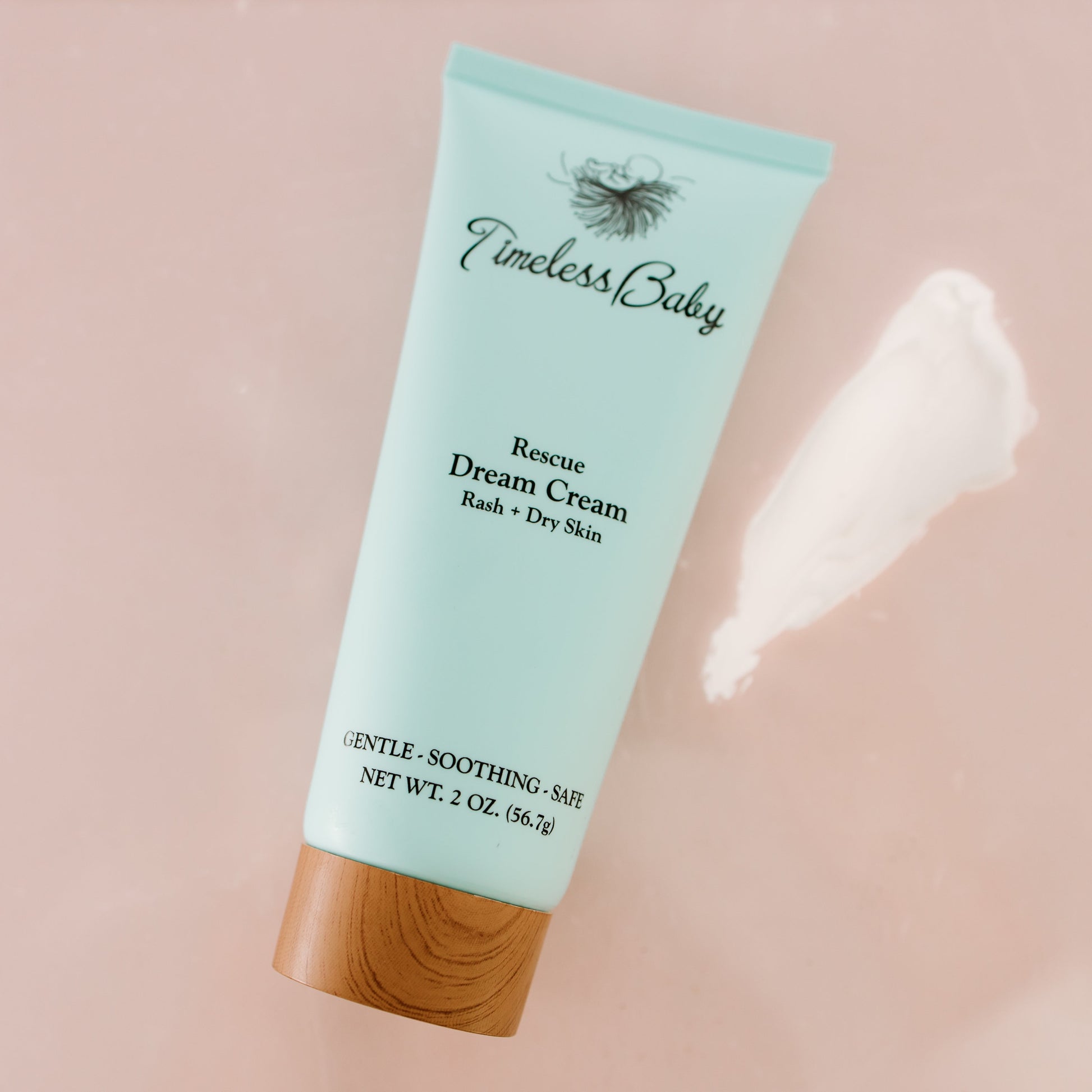 Timeless Baby Dream Cream tube, light blue with wood cap; cream smear near surface