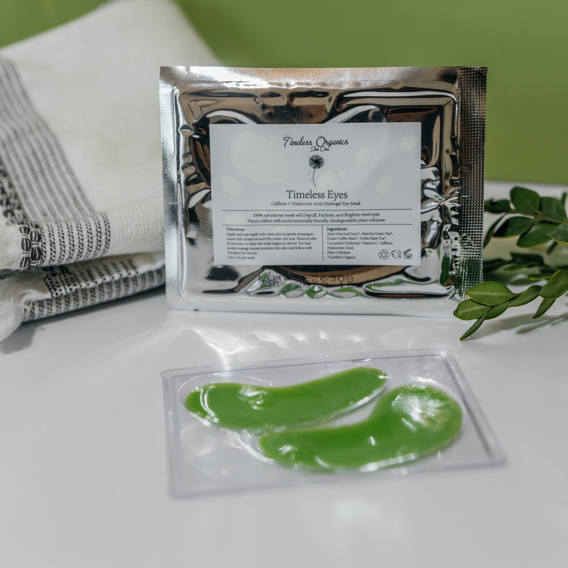 Hydrogel eye masks with foil packet, bright green curved pads in tray.