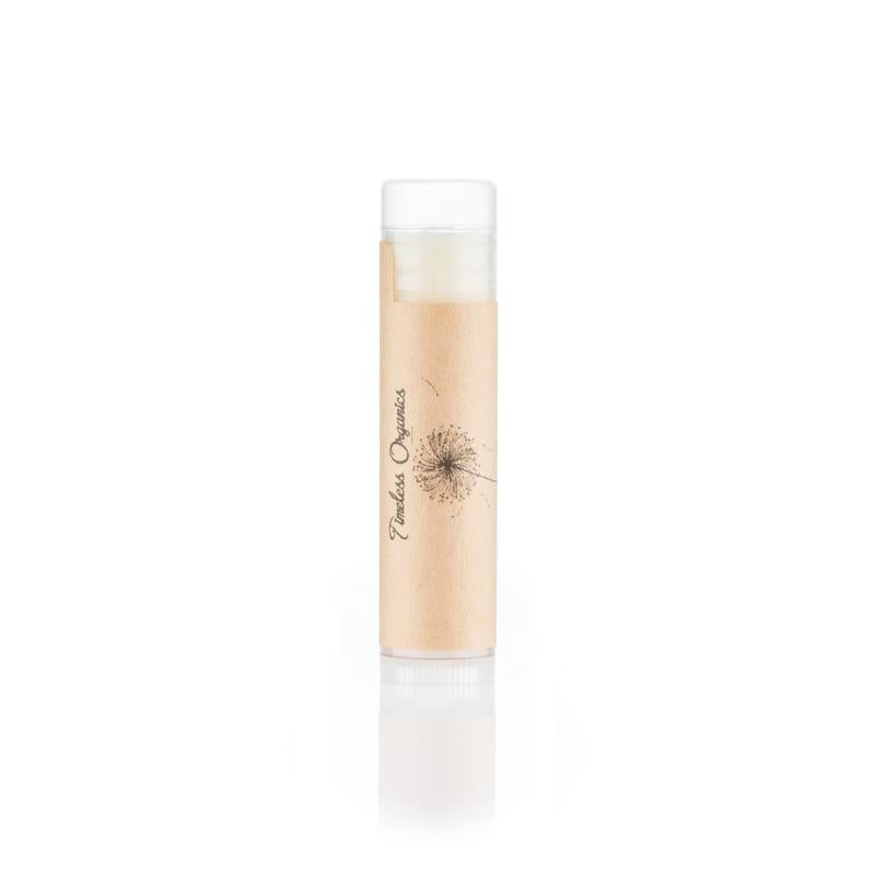 Lip balm tube with clear section and white cap, beige balm, Timeless Organics logo