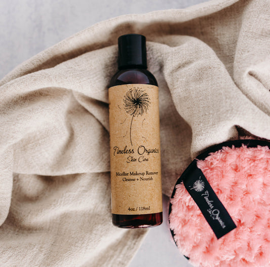 Timeless Organics micellar cleansing water bottle with plush pink cloth nearby