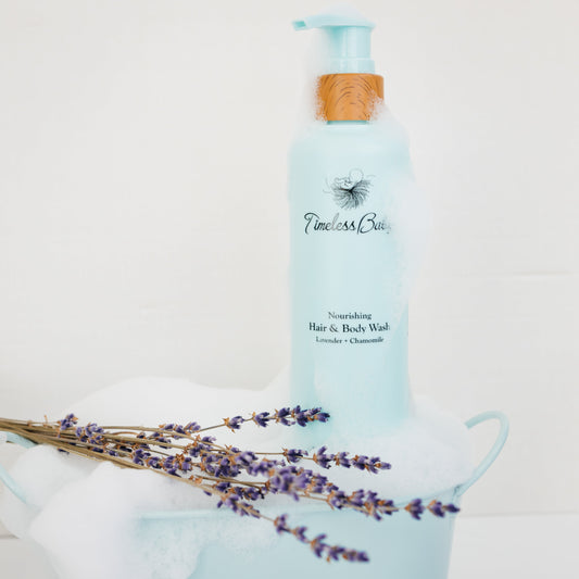 Light blue baby hair & body wash bottle with wooden pump, side view
