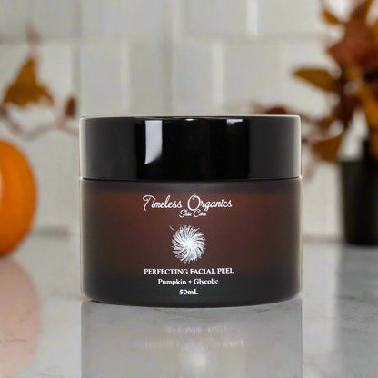 Pumpkin & glycolic facial peel jar with glossy black lid and dark amber container.