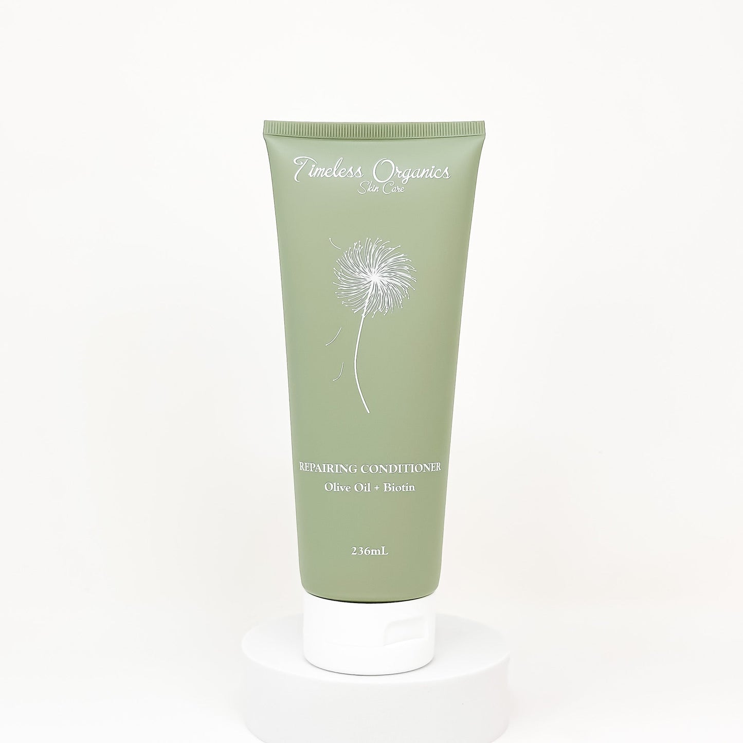 Green repairing conditioner tube labeled Olive Oil + Biotin, 236mL