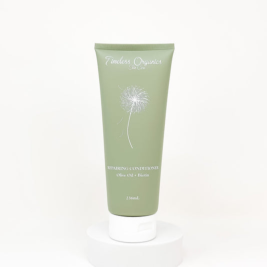 Green repairing conditioner tube labeled Olive Oil + Biotin, 236mL