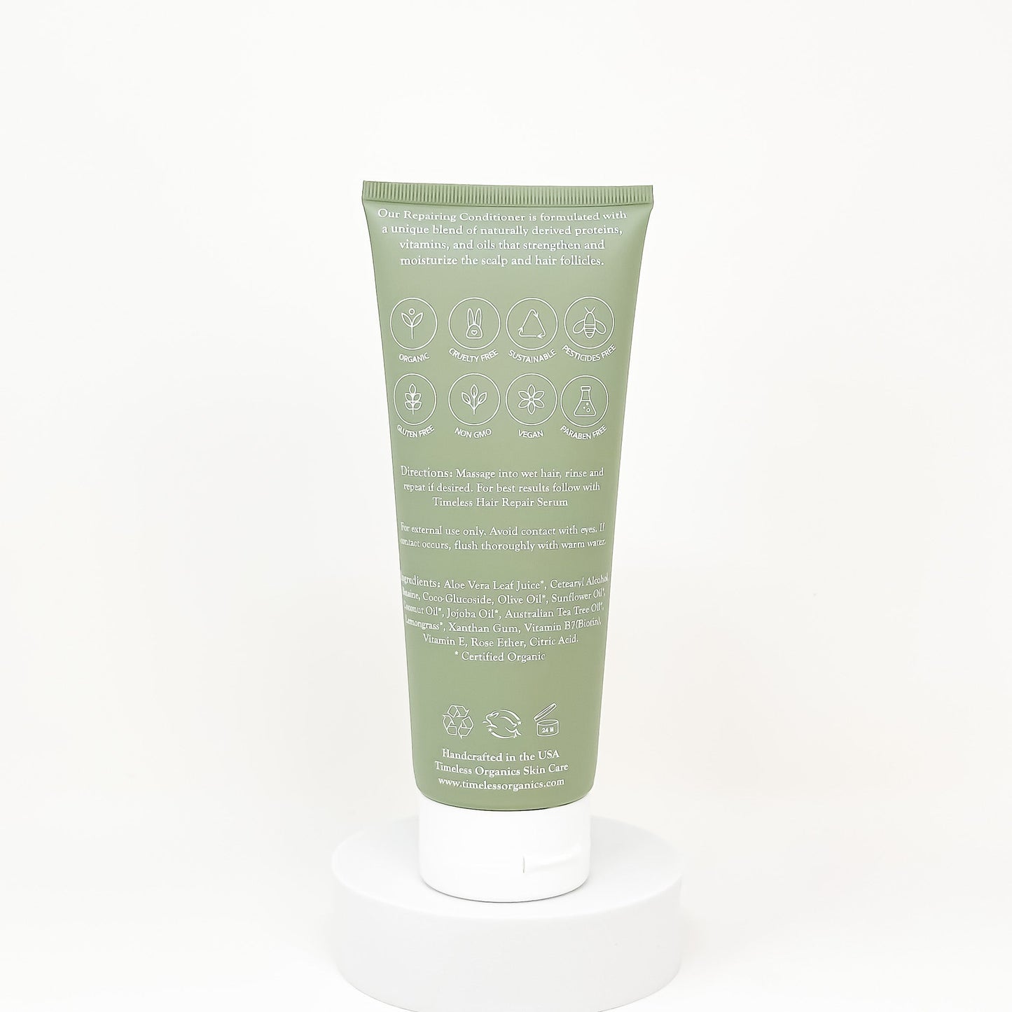 Back of green conditioner tube with ingredient icons and product details text