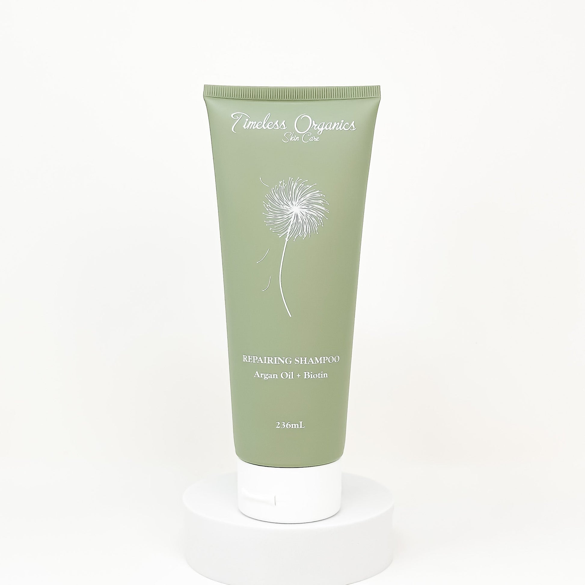 Timeless Organics repairing shampoo tube, green front with argan oil and biotin label