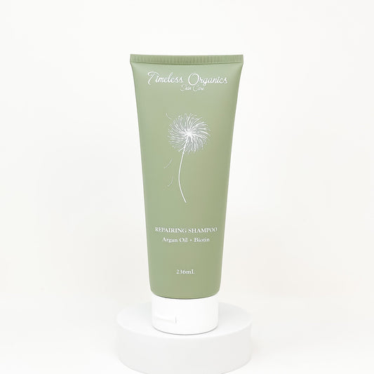 Timeless Organics repairing shampoo tube, green front with argan oil and biotin label
