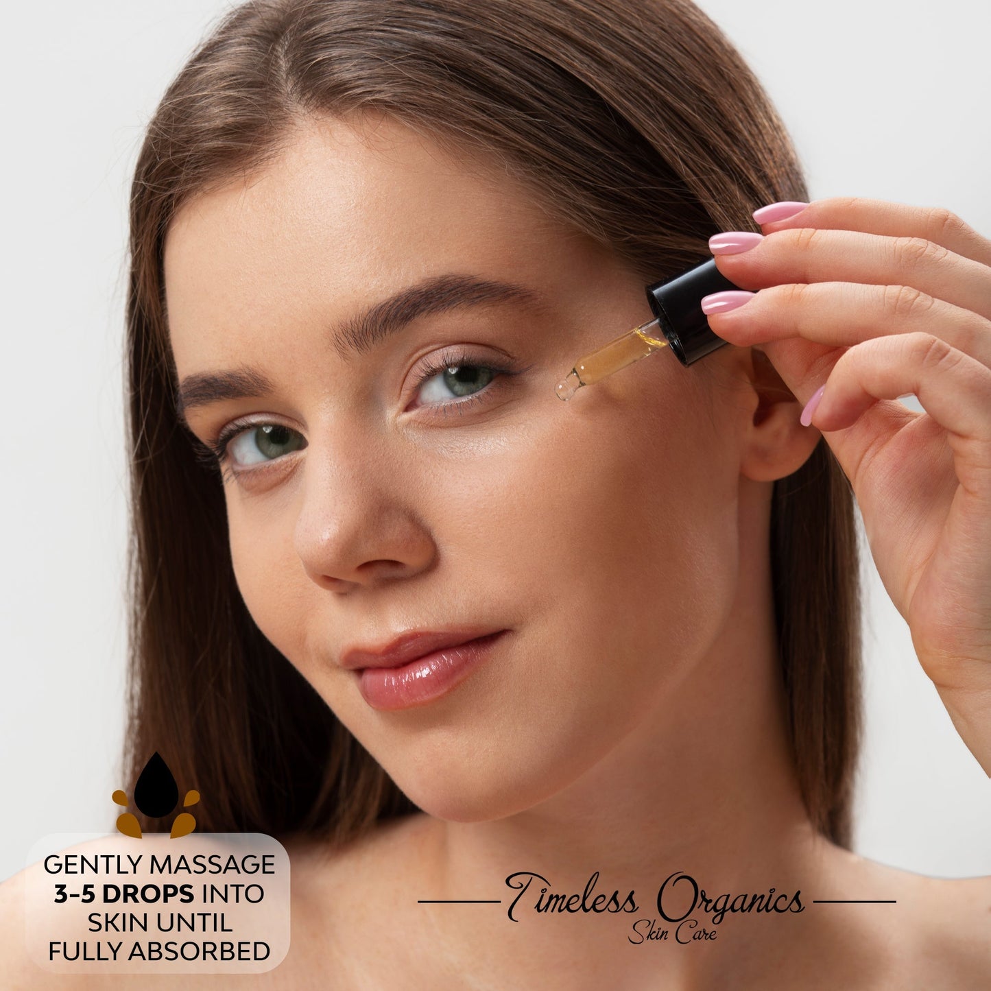 Face oil dropper applying yellow oil to cheek with bottle held near face