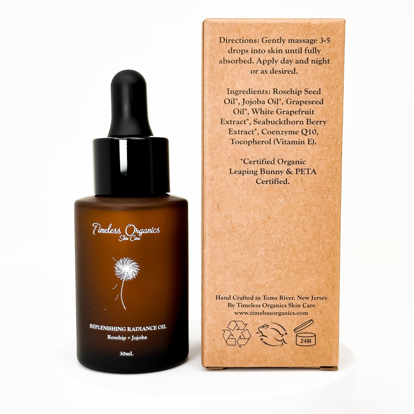 Face oil bottle with black dropper and amber glass next to kraft product box