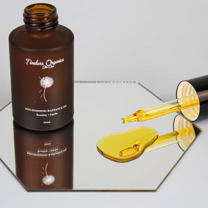 Face oil bottle with black cap and amber oil-filled dropper