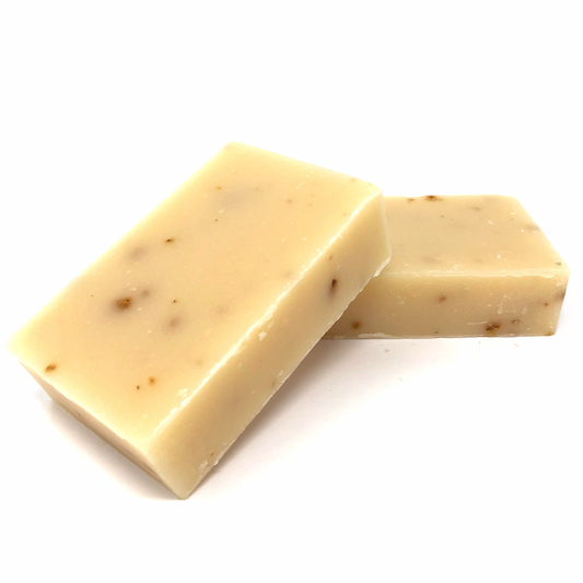 Exfoliating bar soap, cream with specks; two stacked soap blocks