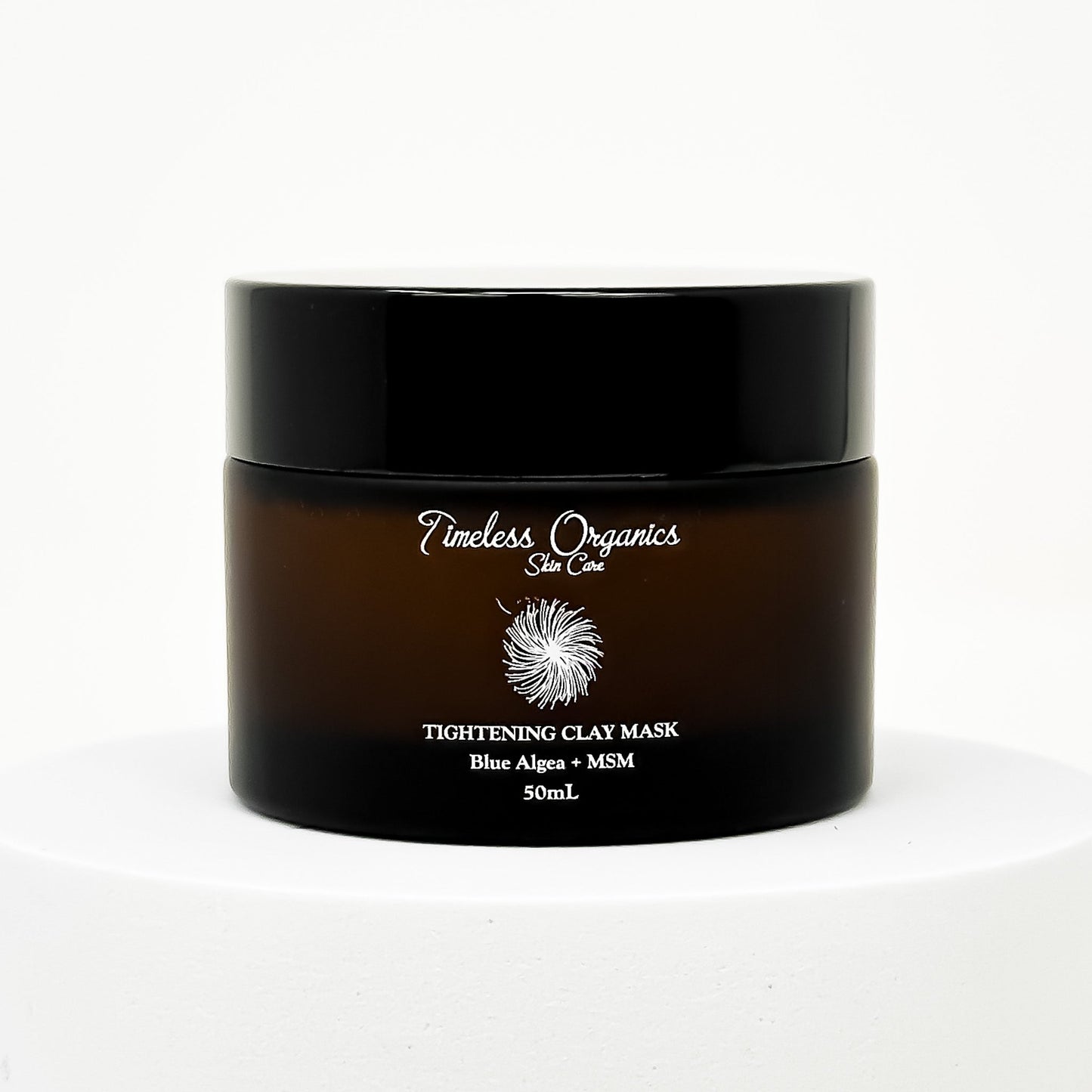 Tightening clay face mask jar with black lid and front product label
