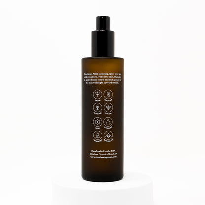 Hydrating face & body mist bottle with black pump, amber bottle, back label icons