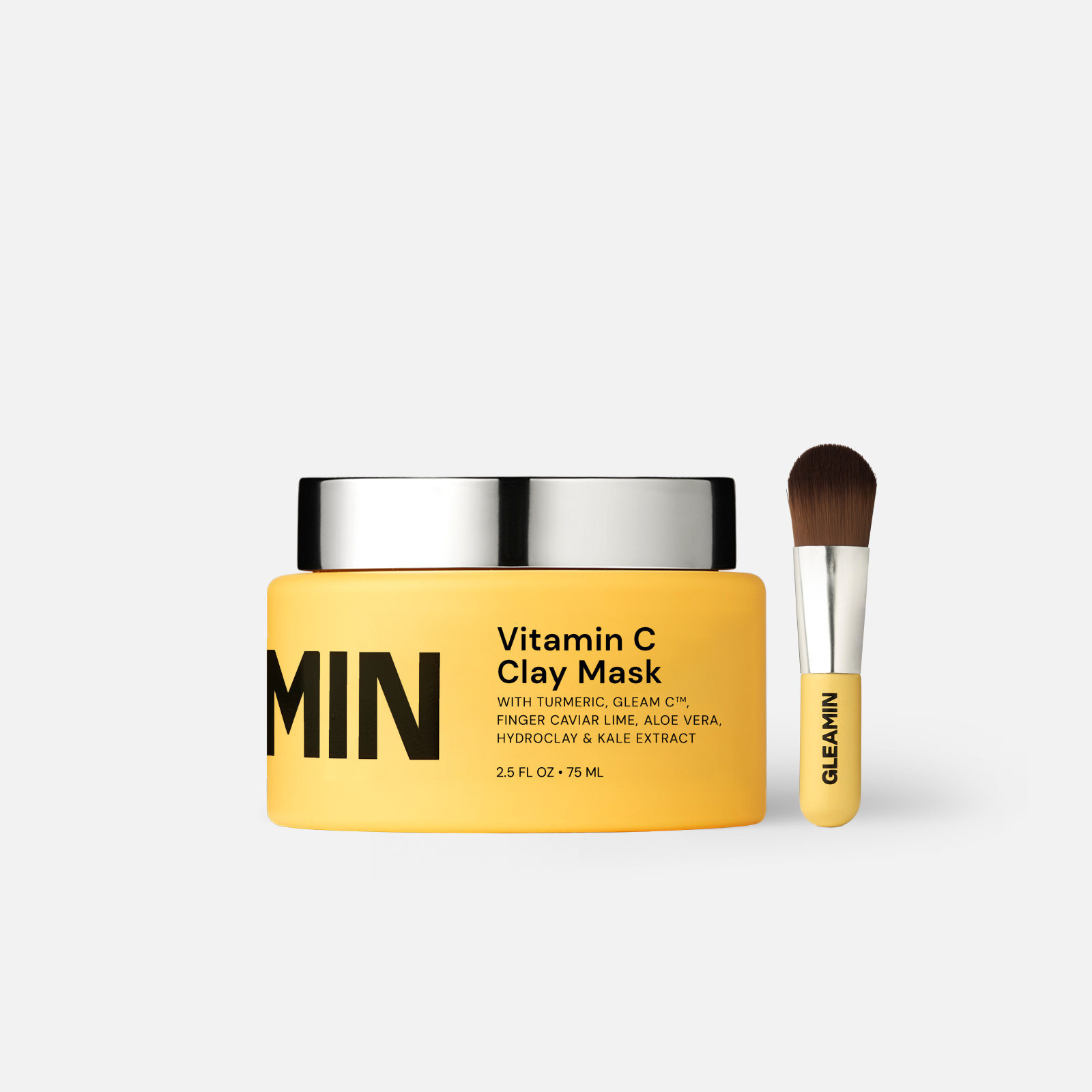 Vitamin C clay mask jar with yellow cream and silver lid, plus gel applicator brush