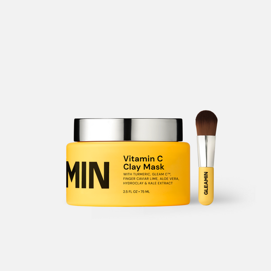 Vitamin C clay mask jar with yellow cream and silver lid, plus gel applicator brush