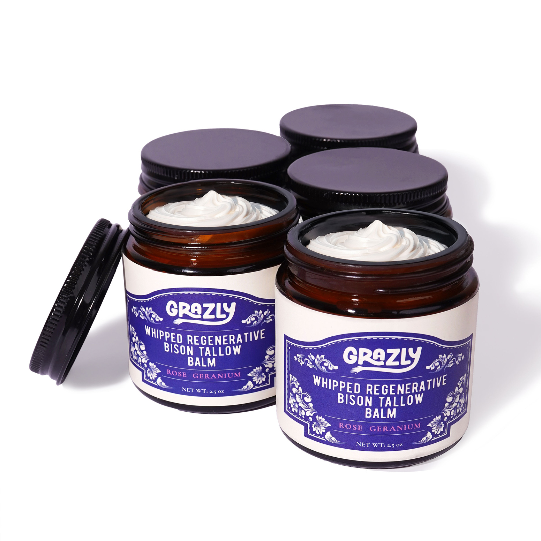Three whipped regenerative bison tallow balm jars with open lids, Rose Geranium scent